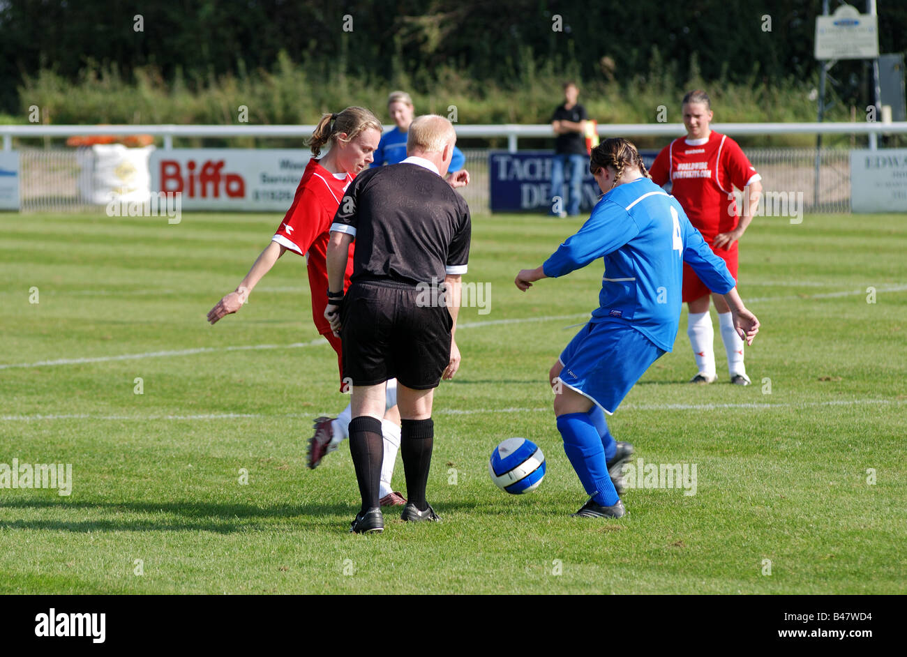 Referee doing drop ball in women`s football, Leamington Spa, England